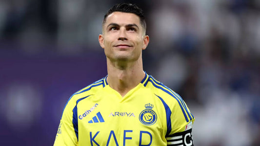 Proud footballer wearing the vibrant al nassr away kit 24/25, inspiring fans to show their passion